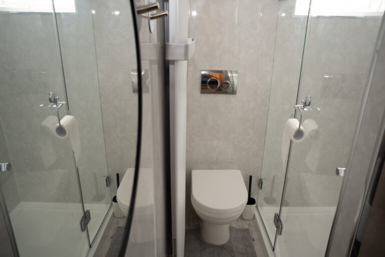 Walk-in glass shower and toilet in the shower room.
